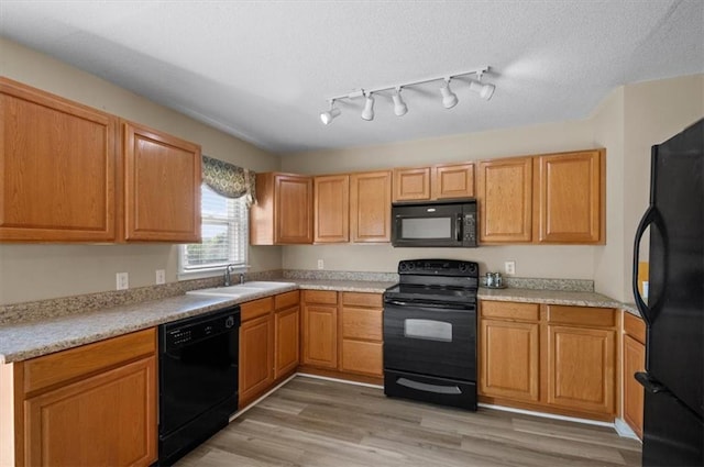 802 W 39th St N, Independence, MO 64050 - kitchen featuring black appliances, light countertops, and light wood-type flooring