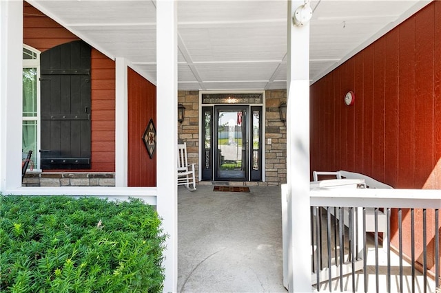 1310 Norfolk Dr, Harrisonville, MO 64701 - view of exterior entry with stone siding and covered porch