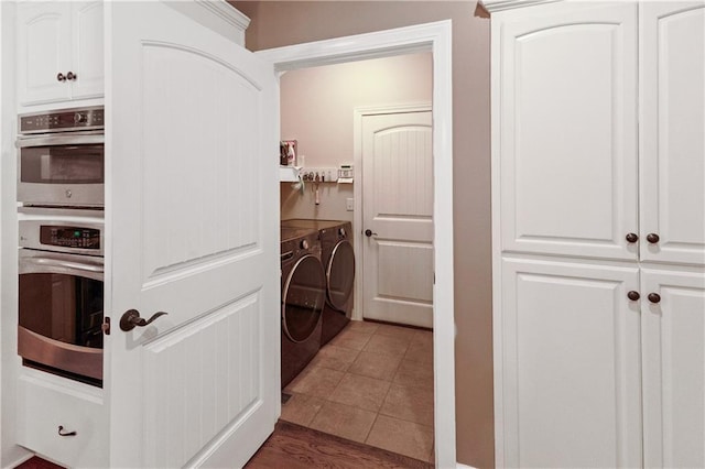 1310 Norfolk Dr, Harrisonville, MO 64701 - washroom featuring washing machine and clothes dryer and dark tile patterned floors
