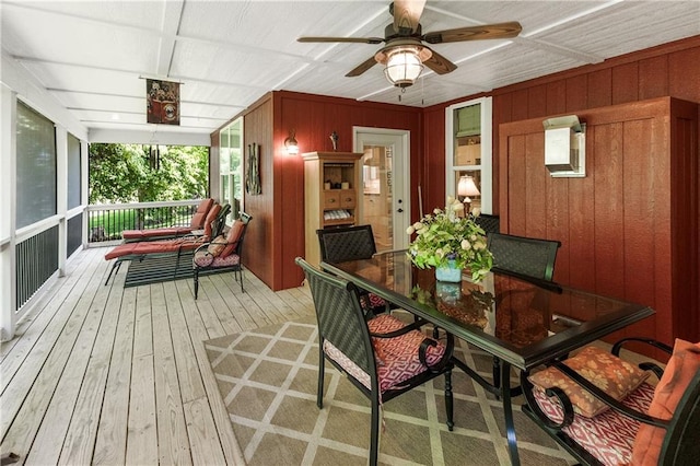 1310 Norfolk Dr, Harrisonville, MO 64701 - dining space featuring a ceiling fan, wood walls, and light wood-style floors