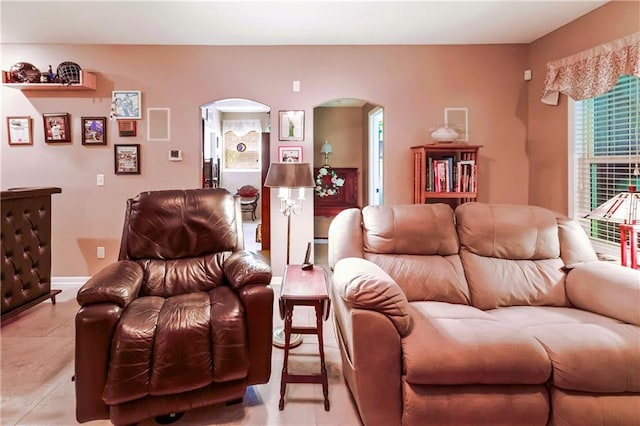 1310 Norfolk Dr, Harrisonville, MO 64701 - living room with arched walkways and light tile patterned flooring