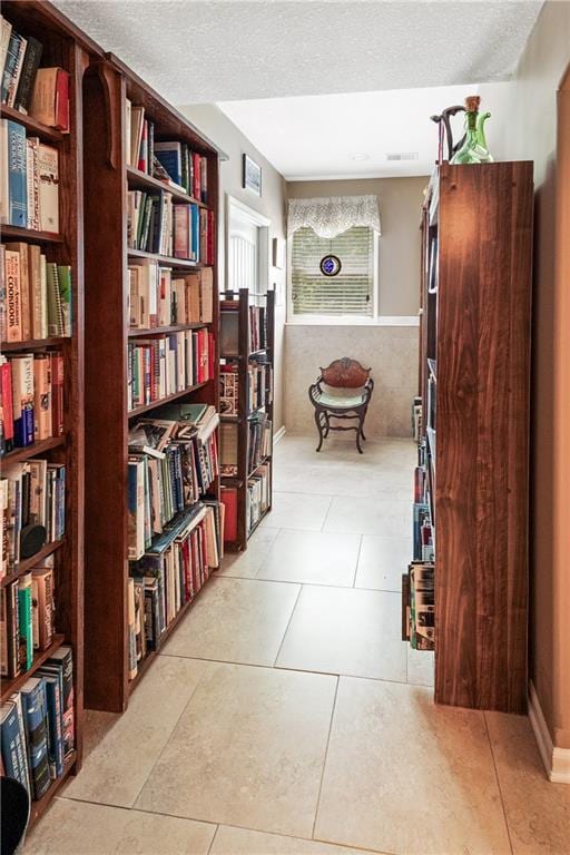 1310 Norfolk Dr, Harrisonville, MO 64701 - hall featuring a textured ceiling and light tile patterned flooring