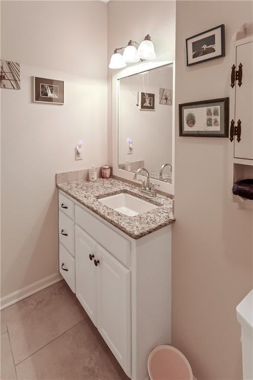 1310 Norfolk Dr, Harrisonville, MO 64701 - half bath with vanity and tile patterned floors