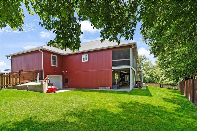 1310 Norfolk Dr, Harrisonville, MO 64701 - back of property featuring stairs, a fenced backyard, an attached garage, and a sunroom