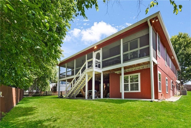1310 Norfolk Dr, Harrisonville, MO 64701 - rear view of property with a sunroom and stairway