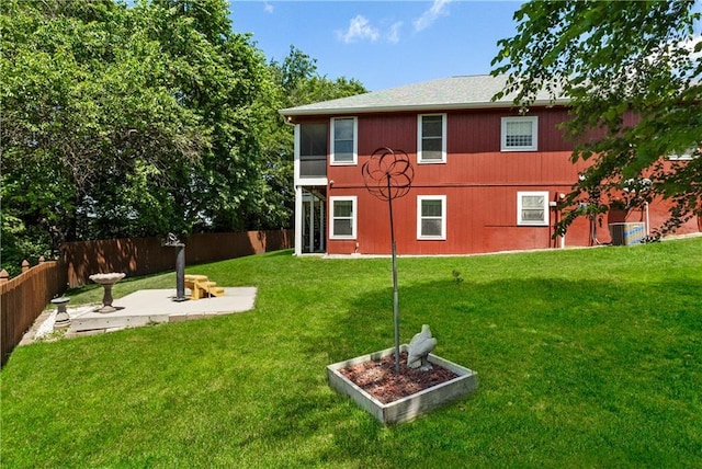 1310 Norfolk Dr, Harrisonville, MO 64701 - rear view of house with a fenced backyard