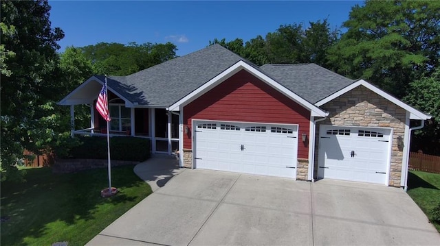 1310 Norfolk Dr, Harrisonville, MO 64701 - ranch-style home featuring stone siding, concrete driveway, a garage, and a shingled roof