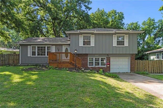 331 E 100th Ter, Kansas City, MO 64114 - view of front of house featuring concrete driveway, a garage, and brick siding
