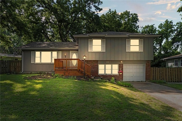 331 E 100th Ter, Kansas City, MO 64114 - view of front of home featuring concrete driveway, an attached garage, and brick siding