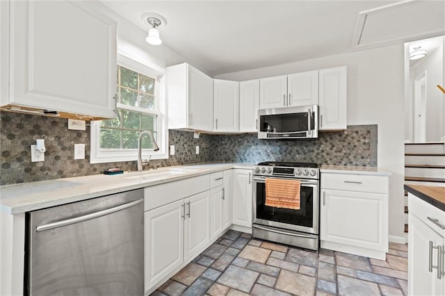 331 E 100th Ter, Kansas City, MO 64114 - kitchen with appliances with stainless steel finishes and white cabinets