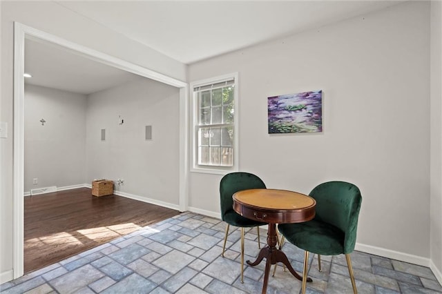331 E 100th Ter, Kansas City, MO 64114 - living area featuring stone tile flooring and baseboards