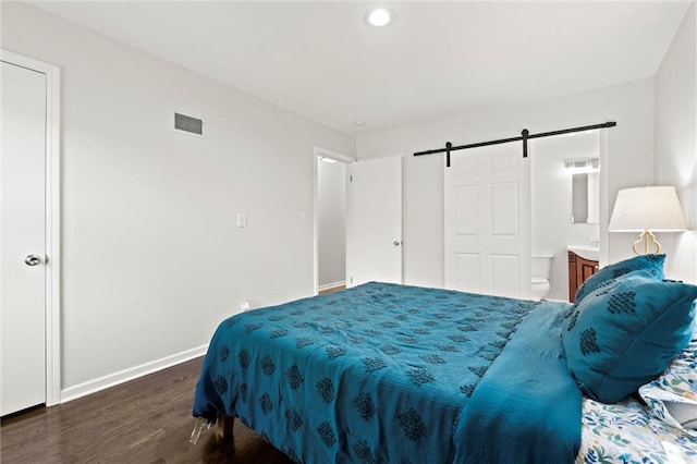 331 E 100th Ter, Kansas City, MO 64114 - bedroom with a barn door, wood finished floors, recessed lighting, and connected bathroom
