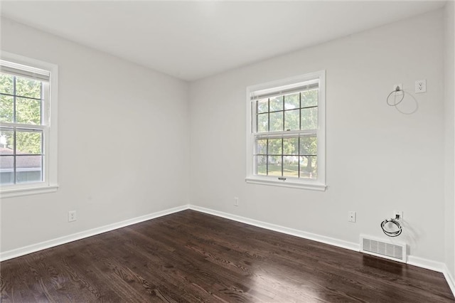 331 E 100th Ter, Kansas City, MO 64114 - unfurnished room featuring plenty of natural light and dark wood-style floors