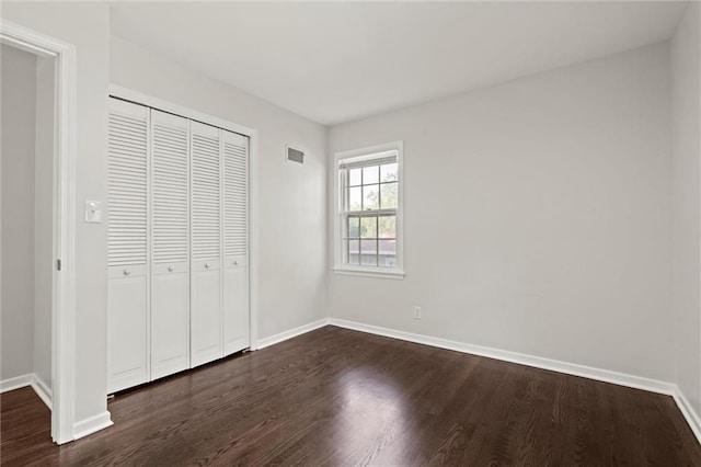 331 E 100th Ter, Kansas City, MO 64114 - unfurnished bedroom featuring dark wood-style floors and a closet