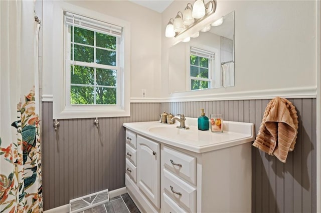 331 E 100th Ter, Kansas City, MO 64114 - bathroom with a wainscoted wall, vanity, and a shower with curtain