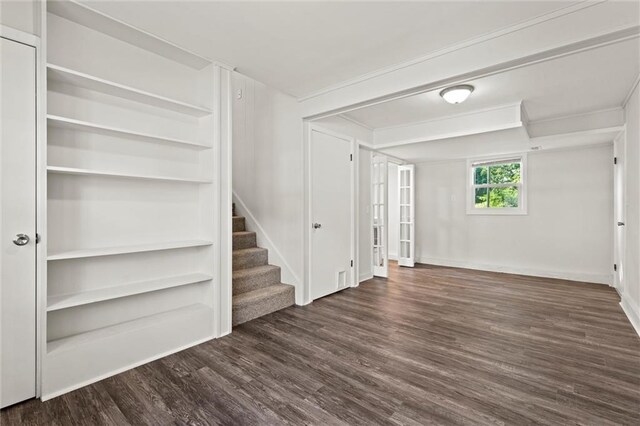 331 E 100th Ter, Kansas City, MO 64114 - unfurnished living room featuring wood finished floors and stairway