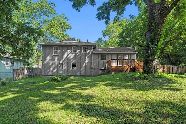 331 E 100th Ter, Kansas City, MO 64114 - back of house featuring a fenced backyard, a deck, board and batten siding, and stairs