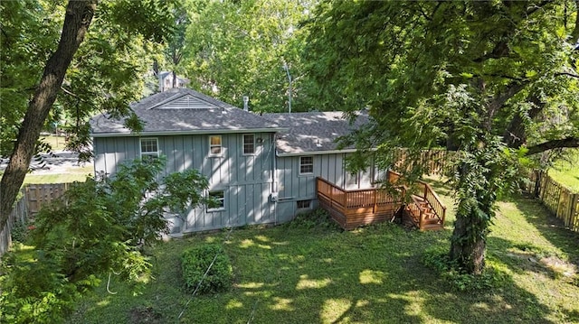331 E 100th Ter, Kansas City, MO 64114 - back of property featuring roof with shingles, a fenced backyard, a wooden deck, and board and batten siding