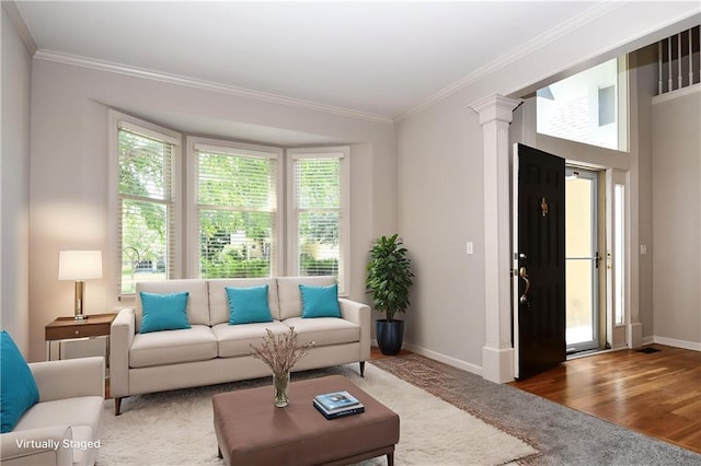 11912 W 132nd St, Overland Park, KS 66213 - living area with crown molding, decorative columns, and wood finished floors
