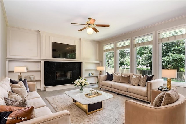 11912 W 132nd St, Overland Park, KS 66213 - living area featuring a ceiling fan, ornamental molding, a high end fireplace, and built in shelves