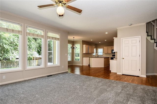 11912 W 132nd St, Overland Park, KS 66213 - unfurnished living room featuring dark colored carpet, ornamental molding, ceiling fan, stairs, and a chandelier