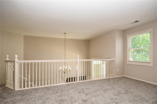 11912 W 132nd St, Overland Park, KS 66213 - unfurnished room featuring carpet flooring, a textured ceiling, and a chandelier