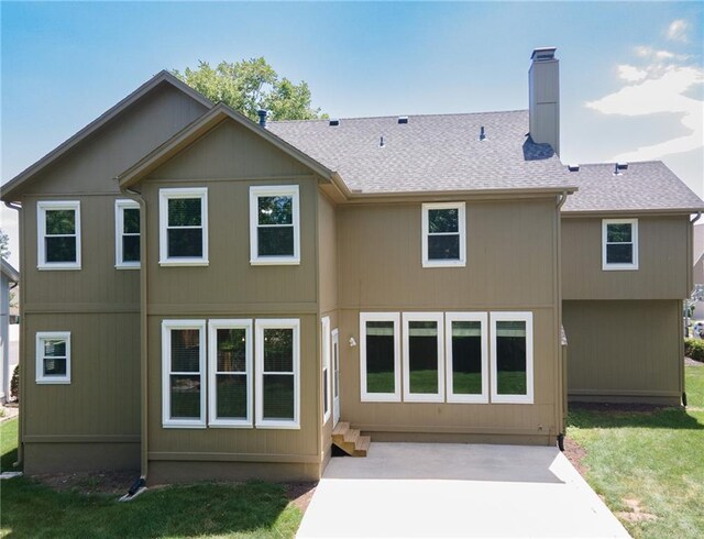 11912 W 132nd St, Overland Park, KS 66213 - back of house with a patio area, a yard, a chimney, and roof with shingles