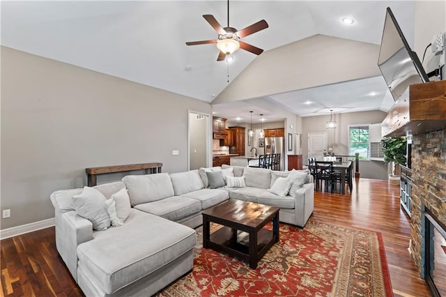 4890 NW Linder Ln, Riverside, MO 64150 - living room with a ceiling fan, vaulted ceiling, a glass covered fireplace, dark wood-style flooring, and recessed lighting