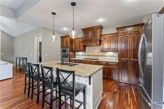 4890 NW Linder Ln, Riverside, MO 64150 - kitchen with stainless steel appliances, dark wood-style floors, tasteful backsplash, hanging light fixtures, and recessed lighting