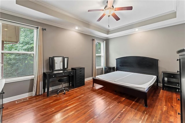 4890 NW Linder Ln, Riverside, MO 64150 - bedroom with a raised ceiling, crown molding, multiple windows, wood finished floors, and a ceiling fan