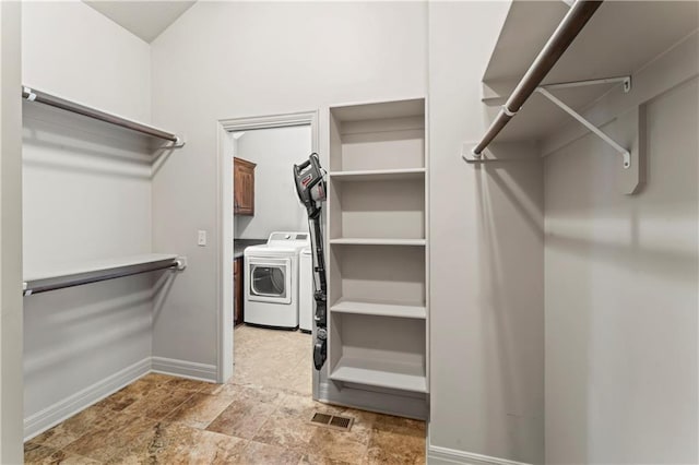 4890 NW Linder Ln, Riverside, MO 64150 - walk in closet featuring washer and dryer and light stone finish floors