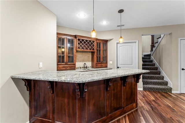 4890 NW Linder Ln, Riverside, MO 64150 - indoor wet bar with dark wood-type flooring, stairs, pendant lighting, tasteful backsplash, and recessed lighting