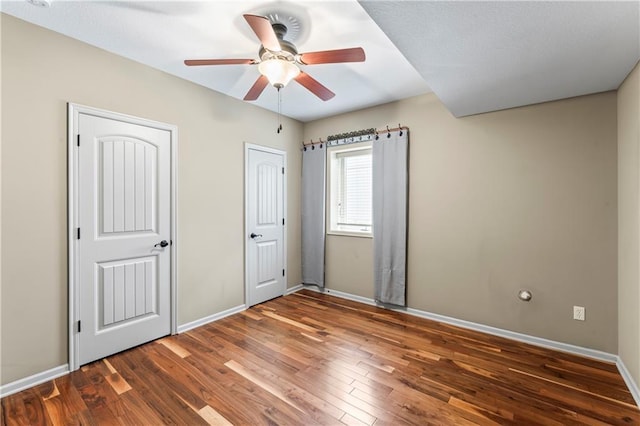 4890 NW Linder Ln, Riverside, MO 64150 - unfurnished bedroom featuring wood finished floors and a ceiling fan