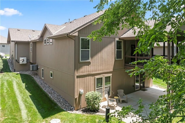 4890 NW Linder Ln, Riverside, MO 64150 - back of house with a shingled roof, a patio area, and a lawn