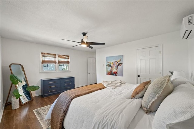 236 W Park St, Gardner, KS 66030 - bedroom with a wall mounted AC, dark wood finished floors, and ceiling fan