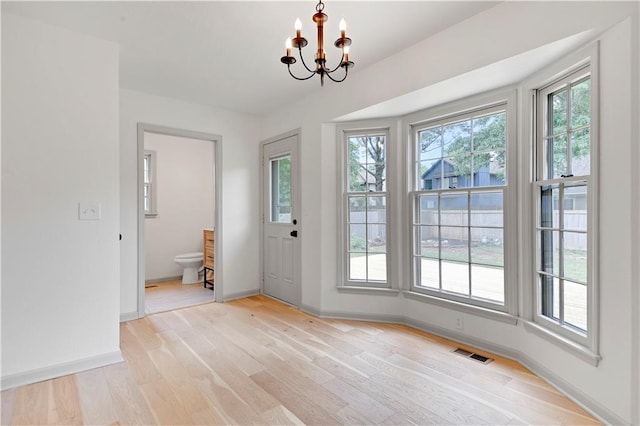 16117 W 125th Ter, Olathe, KS 66062 - foyer entrance featuring plenty of natural light, a chandelier, and light wood-style floors