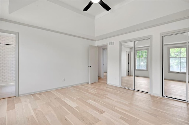 16117 W 125th Ter, Olathe, KS 66062 - unfurnished bedroom with light wood-style flooring, two closets, connected bathroom, and ceiling fan