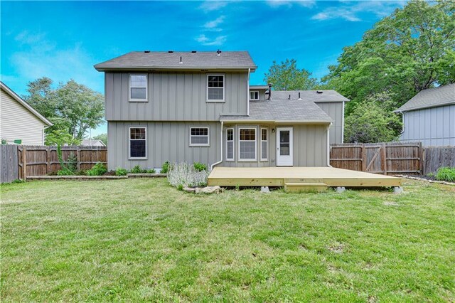 16117 W 125th Ter, Olathe, KS 66062 - rear view of house with board and batten siding, a wooden deck, a fenced backyard, and a shingled roof