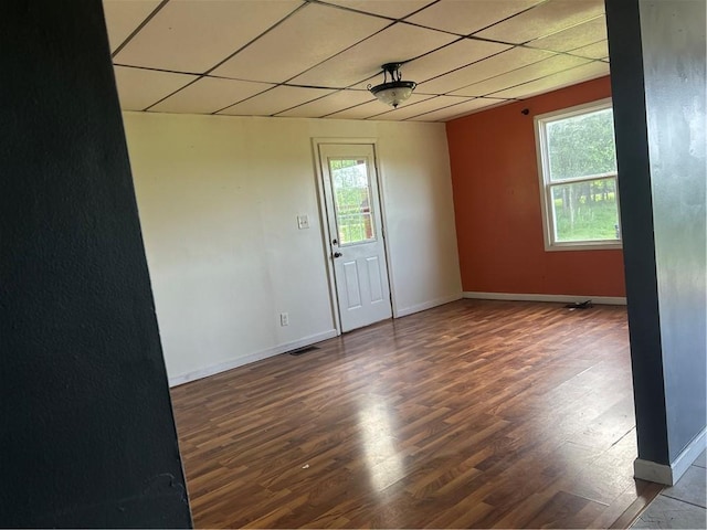 10 Platte St, Dearborn, MO 64439 - spare room featuring a paneled ceiling, healthy amount of natural light, and wood finished floors