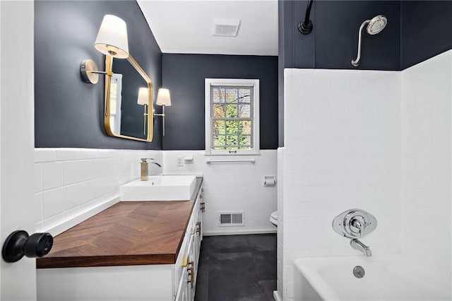 3322 W 95th St, Leawood, KS 66206 - full bathroom with vanity, washtub / shower combination, a wainscoted wall, and tile walls