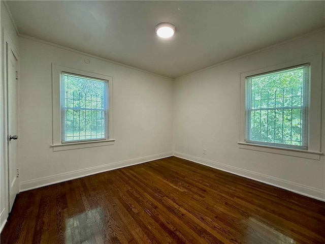 2416 E 70th St, Kansas City, MO 64132 - spare room with ornamental molding, dark wood-style floors, and healthy amount of natural light