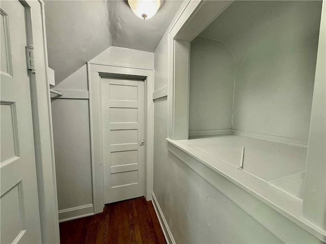 2416 E 70th St, Kansas City, MO 64132 - spacious closet with dark wood-style flooring and vaulted ceiling
