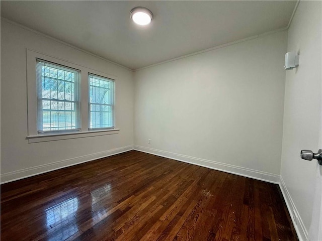 2416 E 70th St, Kansas City, MO 64132 - spare room with crown molding and dark wood finished floors