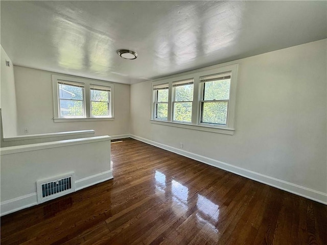 2416 E 70th St, Kansas City, MO 64132 - empty room with baseboards and wood finished floors