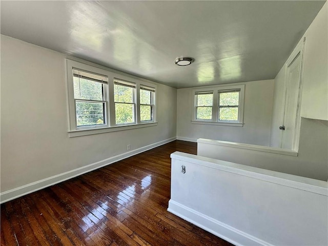 2416 E 70th St, Kansas City, MO 64132 - empty room featuring hardwood / wood-style floors and baseboards
