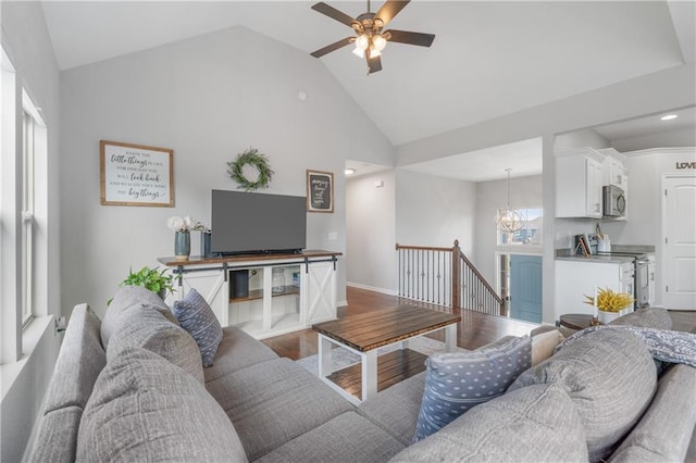 2712 E Sycamore St, Tonganoxie, KS 66086 - living area featuring high vaulted ceiling, a ceiling fan, wood finished floors, and a chandelier