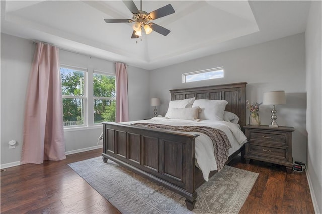 2712 E Sycamore St, Tonganoxie, KS 66086 - bedroom with a tray ceiling, dark wood-style flooring, and ceiling fan