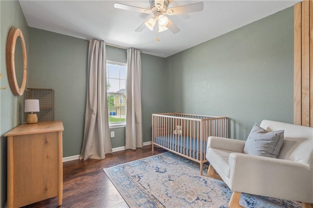 2712 E Sycamore St, Tonganoxie, KS 66086 - bedroom with wood finished floors, a nursery area, and a ceiling fan