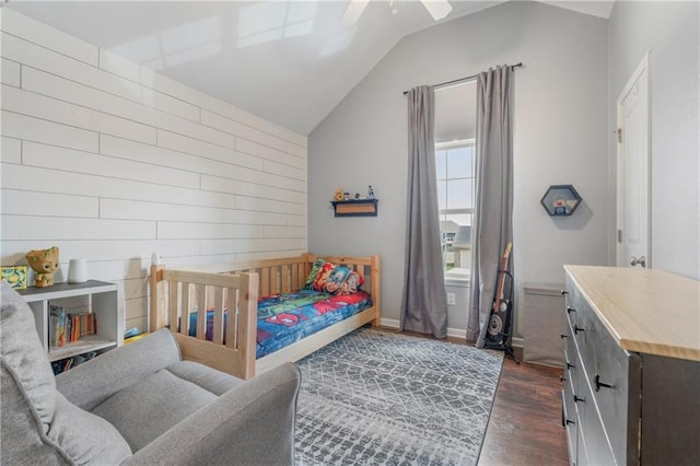 2712 E Sycamore St, Tonganoxie, KS 66086 - bedroom featuring vaulted ceiling, dark wood-style floors, a ceiling fan, and wooden walls