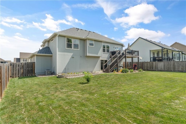 2712 E Sycamore St, Tonganoxie, KS 66086 - back of property with stairs, a fenced backyard, and a wooden deck